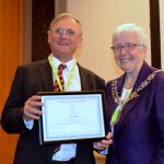 Guy Daines accepting his honorary membership certificate from CILIPS President Margaret Menzies
