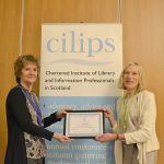 Paulette Hill receiving honorary membership from CILIPS President Theresa Breslin