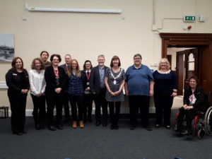 Eleven Librarians in a group for a posed photograph with CILIPS President Yvonne Manning. CILIPS president is wearing the presidential chains of office.