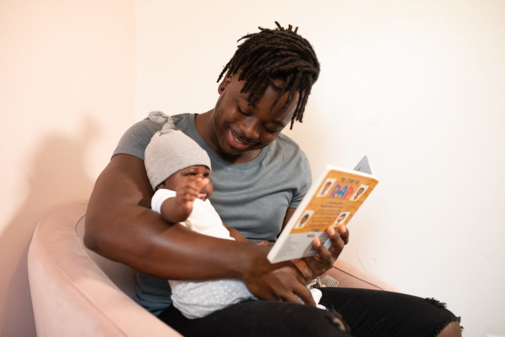 a father sharing a picture book with his young child