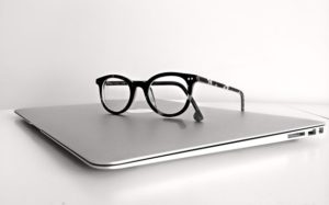 a pair of glasses on top of a laptop