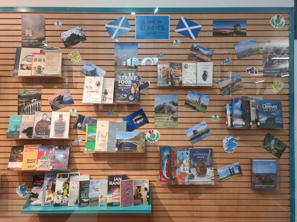 A Year of Stories 2022 book display, with Saltire flags and books from and about Scotland