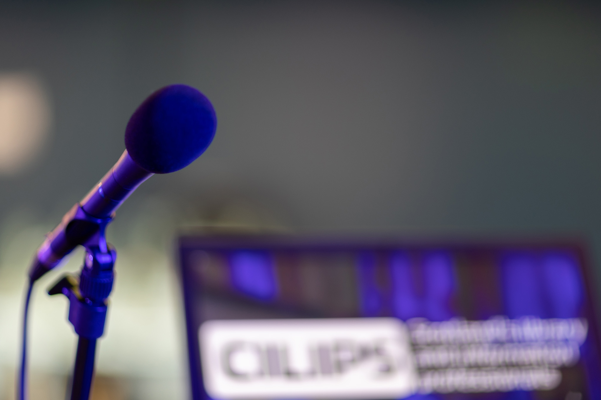A microphone beside a laptop with the CILIPS logo showing.