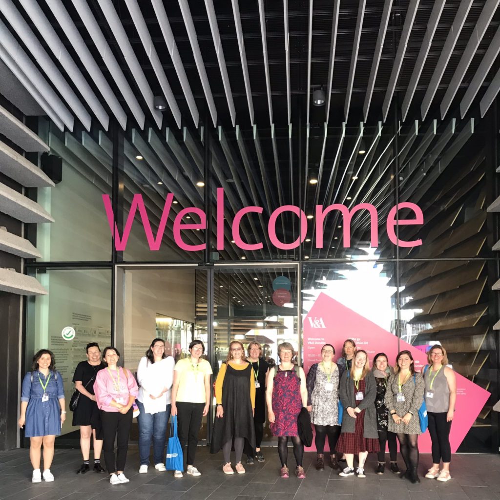 CILIPS22 standing underneath the 'Welcome' sign of V&A Dundee during their visit.