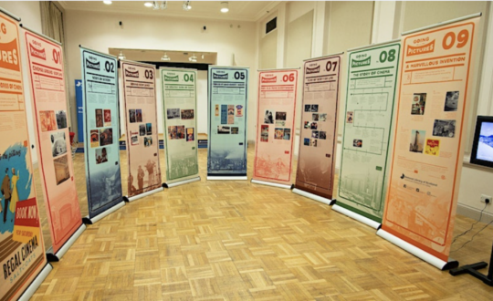 Room in the National Library of Scotland with display banners out in a semi-circle. Showing each of the touring display options.