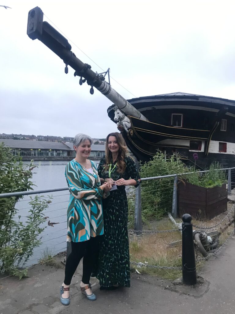 Scotland's Library & Information Professional of the Year 2023 Jennifer Findlay with Helen Bower, Commercial Director of our award sponsor Bolinda Digital, outside the HMS Unicorn in Dundee.