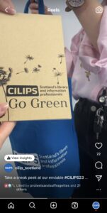 CILIPS staff packing a conference 'swag bag' with an eco-notebook.